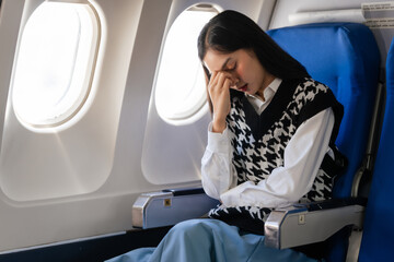 Female asian chinese japanese people passenger experiencing airsickness, clenching sick bag and...