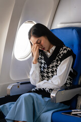 Female asian chinese japanese people passenger experiencing airsickness, clenching sick bag and...