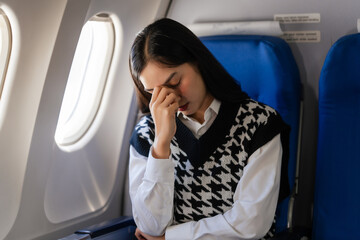 Fototapeta premium Female asian chinese japanese people passenger experiencing airsickness, clenching sick bag and looking uneasy mid-air.