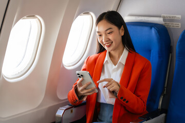 Young asian chinese japanese people female adventurer in-flight, mapping out destinations as she voyages worldwide. woman passenger of airplane. travel around the world.