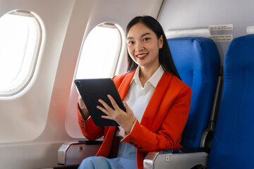 Young asian chinese japanese people female adventurer in-flight, mapping out destinations as she voyages worldwide. woman passenger of airplane. travel around the world.