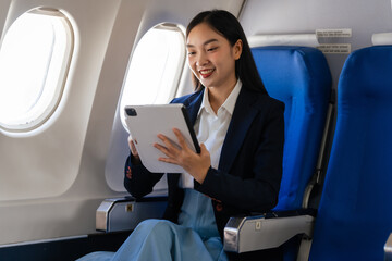 Young asian chinese japanese people female adventurer in-flight, mapping out destinations as she...