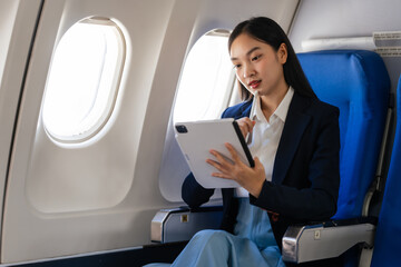 Young asian chinese japanese people female adventurer in-flight, mapping out destinations as she voyages worldwide. woman passenger of airplane. travel around the world.