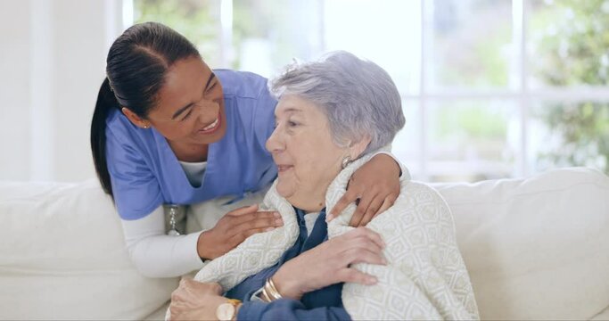 Happy woman, blanket and nurse in elderly care on sofa for support or trust in living room at old age home. Female person, medical or healthcare caregiver helping senior patient in comfort at house