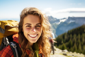 Nature lover woman smiling in jacket and backpack hiking up mountain