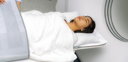 Asian woman patient check up her body by ct scan machine