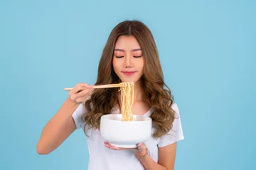 Foto op Plexiglas Asian woman eating hot quick instant noodles © anekoho