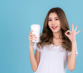Asian woman standing with takeaway coffee paper cup