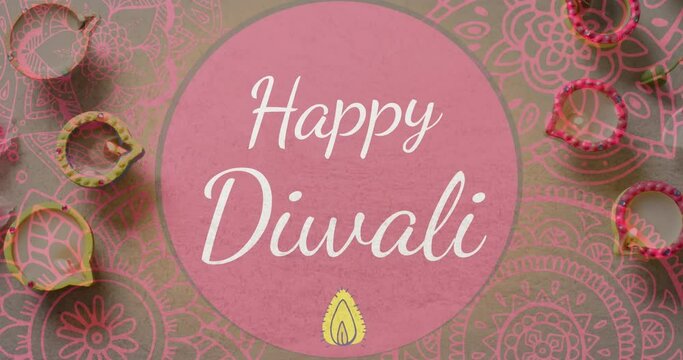 Animation of happy diwali text over candles with pattern on purple background