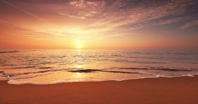 Beautiful sunrise over the sea waves and sandy beach shore, tropical paradise island video