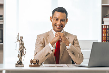 Middle-aged Asian indian people male lawyer meticulously reviews legal documents. Courtroom judge...