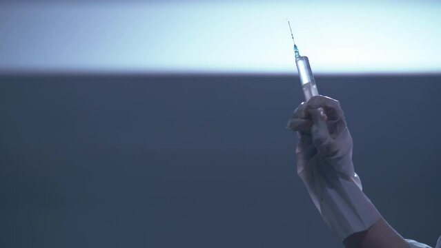 Subterranean Healthcare: Woman Administering Injection in Dimly Lit Room with Syringe