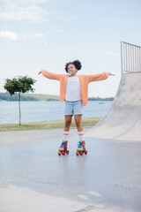 A teenage girl is rollerblading in a summer park. The concept of summer recreation outdoors.
