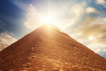 The Top Of The Great Egyptian Pyramid Against A Background Of The Sky With Sun Flares Created Using...