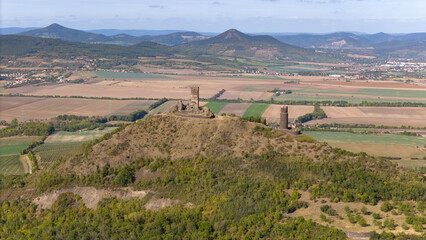 the ruins of the Gothic castle Hazmburk, panorama view, Czech central mountains, aerial view