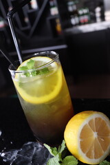 cold water with a slice of lemon fruit and mint leaf