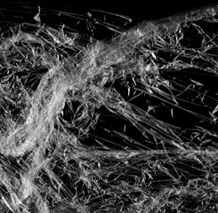 Wrinkled plastic wrap texture on a black background wallpaper. Royalty high-quality free stock photo image of realistic plastic wrap for overlay, copy space and photo effect. Wrinkled plastic surface