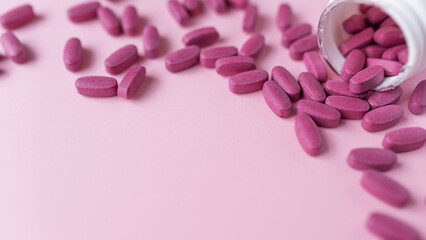 Pink pills Supplements and Vitamins for womens health. Medical health concept. Banner  packground. Flat lay. Copy space