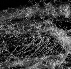 Wrinkled plastic wrap texture on a black background wallpaper. Royalty high-quality free stock photo image of realistic plastic wrap for overlay, copy space and photo effect. Wrinkled plastic surface
