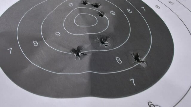 Bullet-Riddled Paper Shooting Target Close-Up
