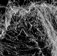 Wrinkled plastic wrap texture on a black background wallpaper. Royalty high-quality free stock photo image of realistic plastic wrap for overlay, copy space and photo effect. Wrinkled plastic surface