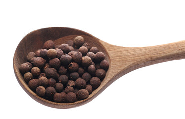 Allspice, pimento spice, Jamaican pepper pile in wooden spoon isolated on white