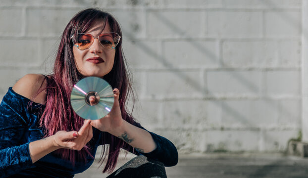 eighties young woman with cd disk in her hand