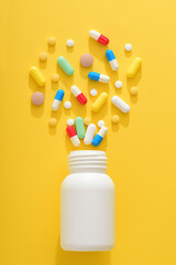 Various tablets and bottles on a yellow background
