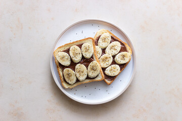 Sandwich with chocolate paste, banana and chia seeds. Breakfast. Vegetarian food.