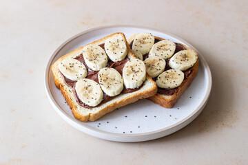 Sandwich with chocolate paste, banana and chia seeds. Breakfast. Vegetarian food.