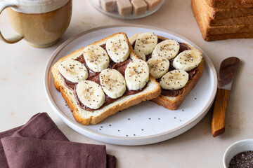 Sandwich with chocolate paste, banana and chia seeds. Breakfast. Vegetarian food.