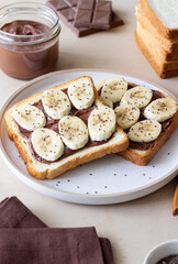 Sandwich with chocolate paste, banana and chia seeds. Breakfast. Vegetarian food.