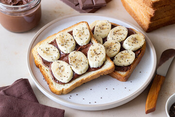 Sandwich with chocolate paste, banana and chia seeds. Breakfast. Vegetarian food.