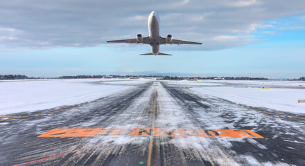 Commercical white airplane fly up over take-off runway the (ice) snow-covered airport- Norway - obrazy, fototapety, plakaty