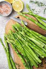 Bunch of raw asparagus stems with different spices