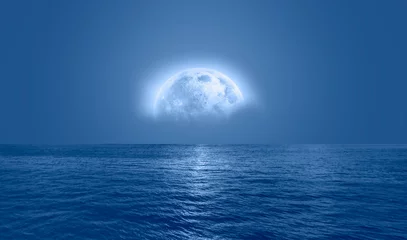 Papier Peint photo Pleine lune Night sky with blue moon in the clouds over the calm blue sea "Elements of this image furnished by NASA