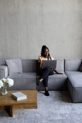 Distant Communication. Happy african woman making video call sitting on couch and talking