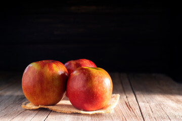 Red apples placed on a wooden table healthy fruits black and dark wood background