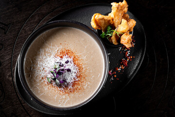 mushroom cream soup in bowlon wooden background