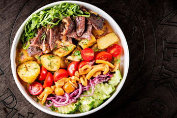 Cobb salad. Classic American salad with tomato, bacon, grilled chicken, mushroom, potato, cucumber on plate