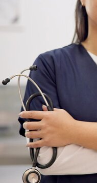 Woman, hand and stethoscope of professional doctor with arms crossed in healthcare or medical service at hospital. Closeup of female person or nurse in confidence with tools or equipment for health