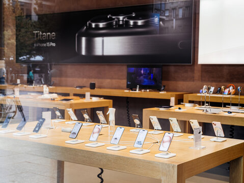 Paris, France - Sep 22, 2023: advertising board in the Apple Store promotes the iPhone 15 Pro, accompanied by rows of new phones and watches in a global unveiling