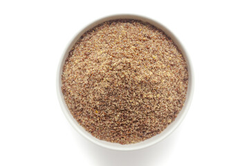 Organic Flaxseed Flour (Linum usitatissimum) in a white ceramic bowl. Isolated on a white background. Top View