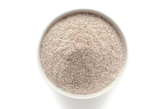 Organic Ragi Flour (Eleusine coracana) or Finger Millet Flour in a white ceramic bowl. Isolated on a white background. Top View