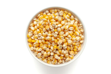 Organic Corn Seeds (Zea mays) or Makka in a white ceramic bowl. Isolated on a white background. Top View