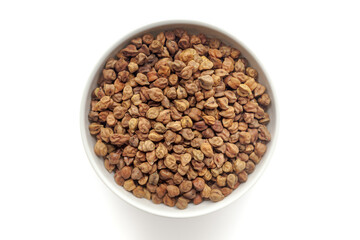 Black organic Chickpeas ( Cicer arietinum) or Kala Chana in a white ceramic bowl. Isolated on a white background. Top View