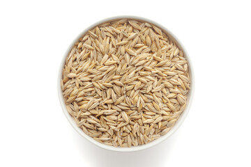 Organic Barley, (Hordeum Vulgare) or jau grains in a white ceramic bowl. Isolated on a white background. Top View