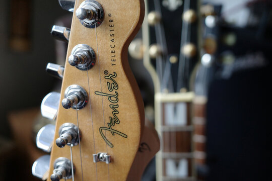 Itterbeck, Germany - Oct 6 2023 Closeup of a guitar head of a Fender Telecaster guitar. Blurred in the background heads other guitars
