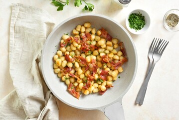 Potato gnocchi with bacon and greens