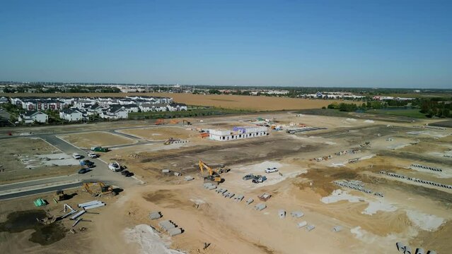 Aerial wide shot of suburb in pre construction empty lots and home